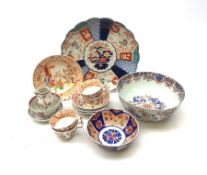 A group of Victorian teawares, comprising four cups, five bowls, and one plate, each decorated with