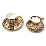 Two Royal Crown Derby Imari pattern tea cups and saucers, the first example with cup of tapering for