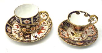 Two Royal Crown Derby Imari pattern tea cups and saucers, the first example with cup of tapering for