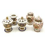 Three Bloor Derby Imari pattern twin handle urms, two examples with covers, each with mark beneath,