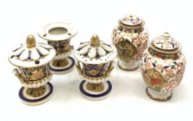 Three Bloor Derby Imari pattern twin handle urms, two examples with covers, each with mark beneath,