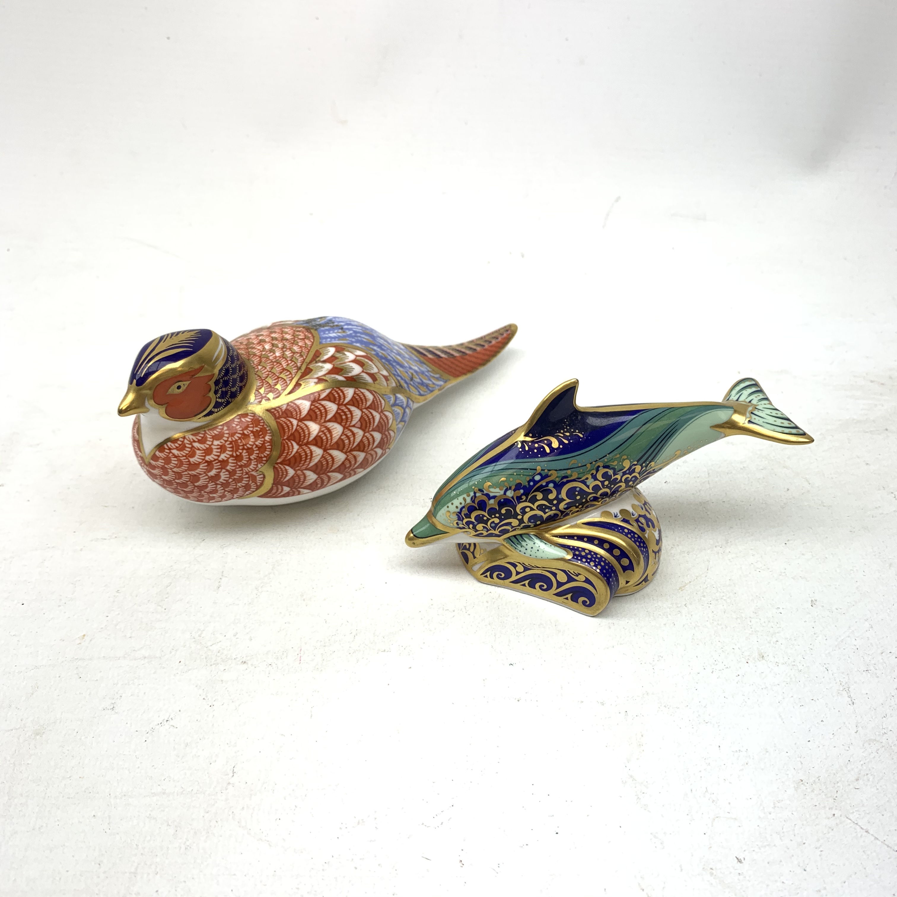 Two Royal Crown Derby paperweights, the first modelled as a Pheasant, the second as a Baby Bottlenos