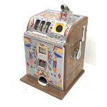 A one arm bandit fruit slot machine, the oak case with cast metal front and top with polychrome deta