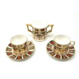 A pair of Royal Crown Derby Imari 1128 coffee cans and saucers, together with a Royal Crown Derby Im