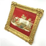 A Tapestry of a greyhound or similar dog, within a glazed swept gilt frame, frame 50cm x 56cm.