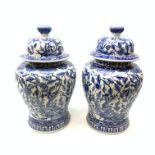A pair of large 20th century blue and white jars and covers, each of baluster form, the domed covers