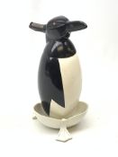 A Russian Soviet period soda siphon, modelled as an enamel penguin, and raised upon a plastic drip t