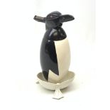 A Russian Soviet period soda siphon, modelled as an enamel penguin, and raised upon a plastic drip t