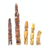 A group of five marine ivory carvings, each modelled as naively carved figures, largest H33.5cm.