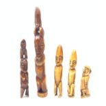 A group of five marine ivory carvings, each modelled as naively carved figures, largest H33.5cm.