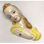 A 20th century American Goldscheider Art Deco wall mask, modelled as a blonde haired female in yello
