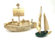 A Japanese carved ivory model of a sailing boat, surmounted by three carved figures (a/f), L22.5cm,
