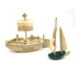 A Japanese carved ivory model of a sailing boat, surmounted by three carved figures (a/f), L22.5cm,