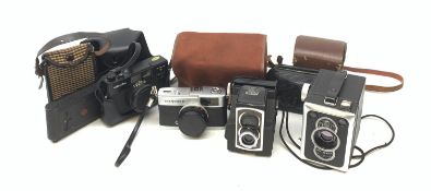 A group of cameras, to include an Olympus Trip 35, a Vest Pocket Kodak Model B, a Minolta H-Matic S,