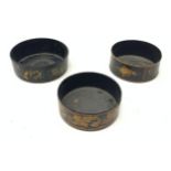 Three Regency black papier mache wine coasters, each with gilt foliate decoration, each approx D13cm