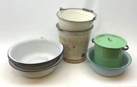 A collection of various enamel basins and buckets.