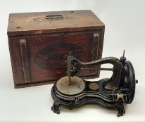 A Vintage Jones hand wind sewing machine, in maker's stamped wooden box.