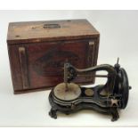 A Vintage Jones hand wind sewing machine, in maker's stamped wooden box.