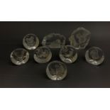 A group of eight Mats Jonasson Swedish intaglio moulded glass paperweights, largest 10.5cm.