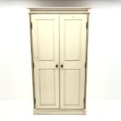 Painted pine double wardrobe, projecting cornice, two doors enclosing single shelf and hanging rail,
