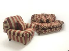 Two seat sofa upholstered in a patterned red and gold fabric, turned supports on castors (W130cm) an