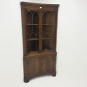 20th century figured mahogany double corner cabinet, dentil frieze above two doors enclosing two she