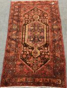 Hamadan red ground rug, central medallion, repeating border, 252cm x 143cm