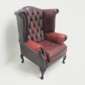 Georgian style wing back leather armchair, upholstered in deep buttoned ox blood leather, W85cm