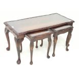 Late 20th century figured mahogany nest of tables, shaped moulded top with inset glass, on cabriole