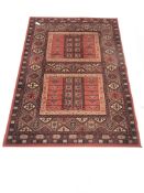 Persian design red ground rug, repeating border, 190cm x 137cm