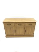 Light oak sideboard, three drawers above three cupboards on plinth base, W137cm