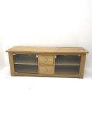 Light oak entertainment cabinet, two glazed doors flanking two drawers, stile supports, W140cm, H50c