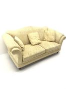 Licoln House three seat sofa, upholstered in a pale gold chenille fabric with floral pattern, shaped