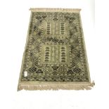 Persian design lime ground rug, repeating border, 140cm x 98cm