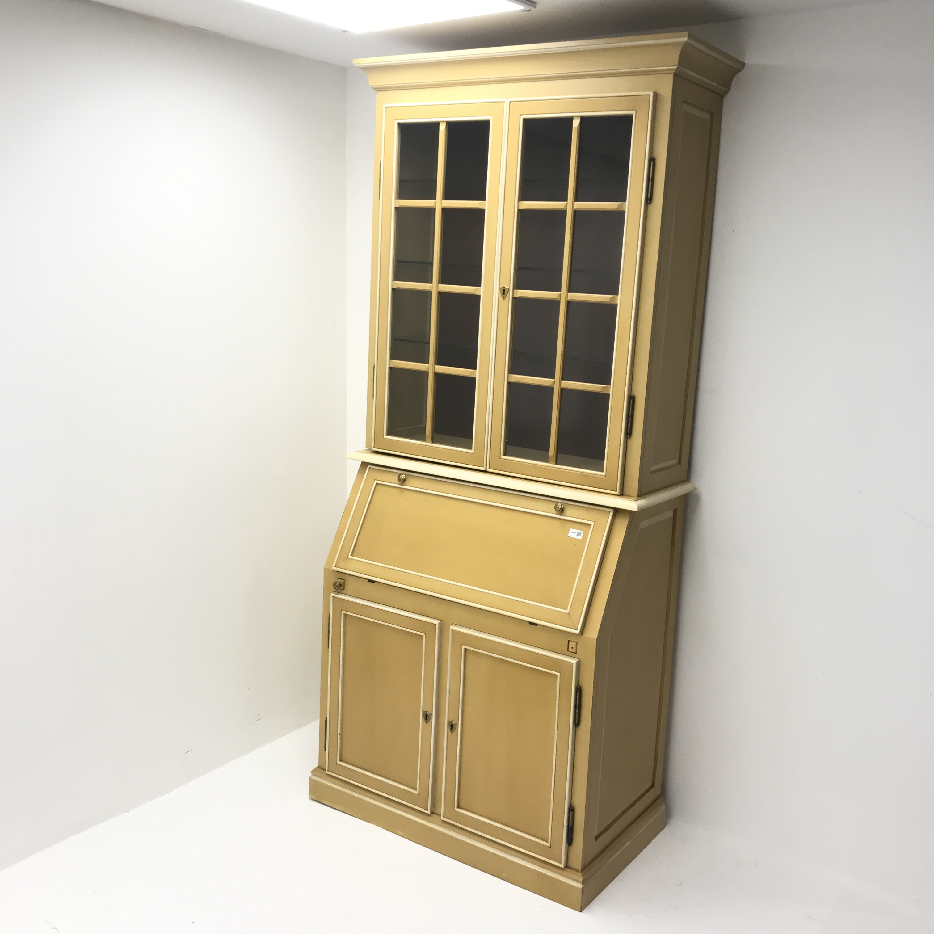 Painted bureau bookcase , projecting cornice, two doors above fall front enclosing fitted interior,