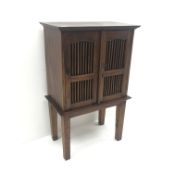 Hardwood cabinet, two doors with spindle panels, square tapering supports, W77cm, H121cm, D43cm