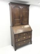 Georgian oak and mahogany bureau bookcase, projecting cornice, dentil frieze, two cupboard doors, fa