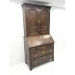 Georgian oak and mahogany bureau bookcase, projecting cornice, dentil frieze, two cupboard doors, fa