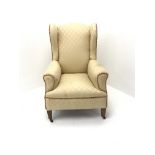 Early 20th century wing back armchair, upholstered in a beige fabric, square tapering supports, W72c