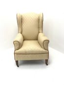 Early 20th century wing back armchair, upholstered in a beige fabric, square tapering supports, W72c