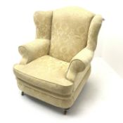 Licoln House wing back armchair, upholstered in a pale gold chenille fabric with floral pattern, sha