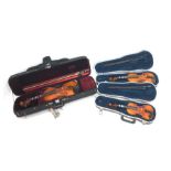 Three modern graduated violins - Suzuki 1/10 size child's violin with 23.5cm single piece back, bear