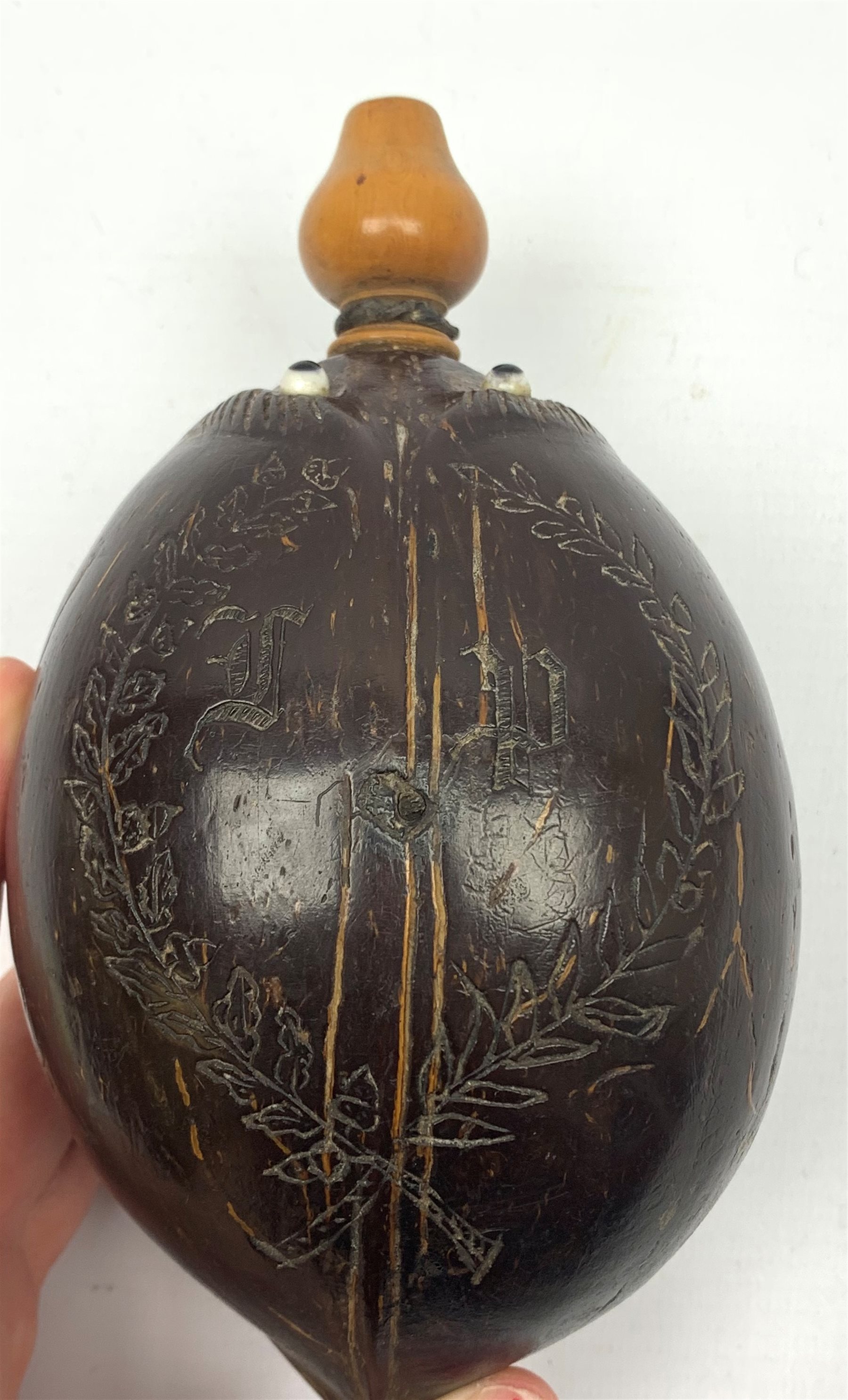 Napoleonic coconut bug bear flask with carved decoration and initials, inset glass eyes and turned b - Image 2 of 6
