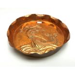 Newlyn School style large circular copper dish, the raised rim with crimped edge and repousse study