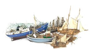 Six various wooden hulled model boats including sailing ships and fishing boats, various stages of c