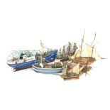 Six various wooden hulled model boats including sailing ships and fishing boats, various stages of c