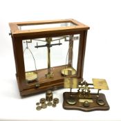 Set of brass laboratory scales by Philip Harris Birmingham in glazed mahogany cabinet with upward sl