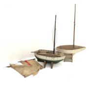 Two pond yachts - one with white and green painted wooden hull, weighted metal keel and simulated pl