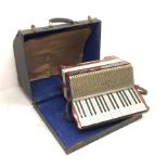 German Hohner Carmen-Vineta piano accordion with decorative red pearline finish, twenty keys and tw