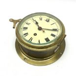 Smiths ship's brass cased bulkhead clock, the cream dial with Roman numerals, black hands and red sw